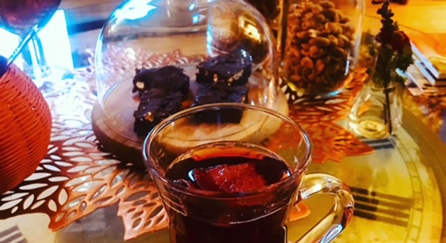 A glass of mulled cider and jars of baked treats