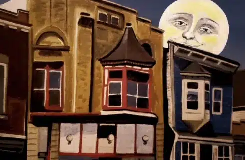 Painting of a moon face overlooking a building in Bay View
