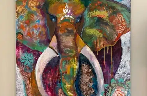 Abstract portrait of a multicolored elephant with white tusks