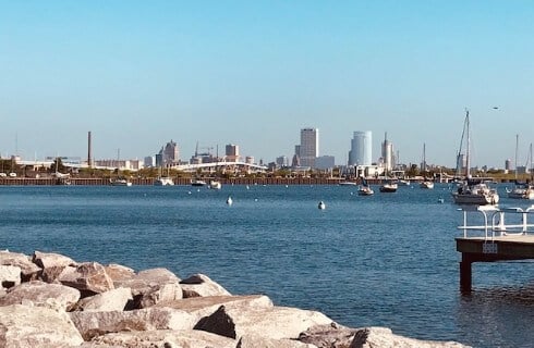 View of Milwaukee shore of Lake Michigan with boats in the harbor.