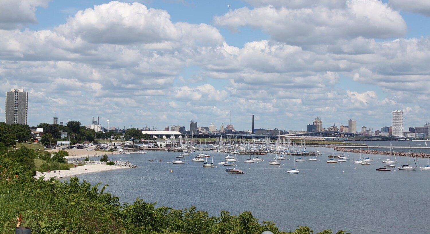 View of Milwaukee shore of Lake Michigan with boats in the harbor.